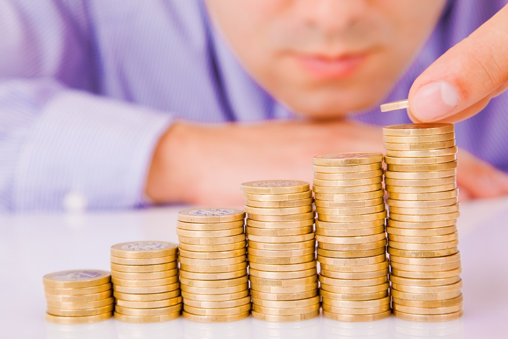 man calculating the cost of living increase