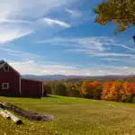 Fall leaves add color to a bright Vermont rural scene in the Fall