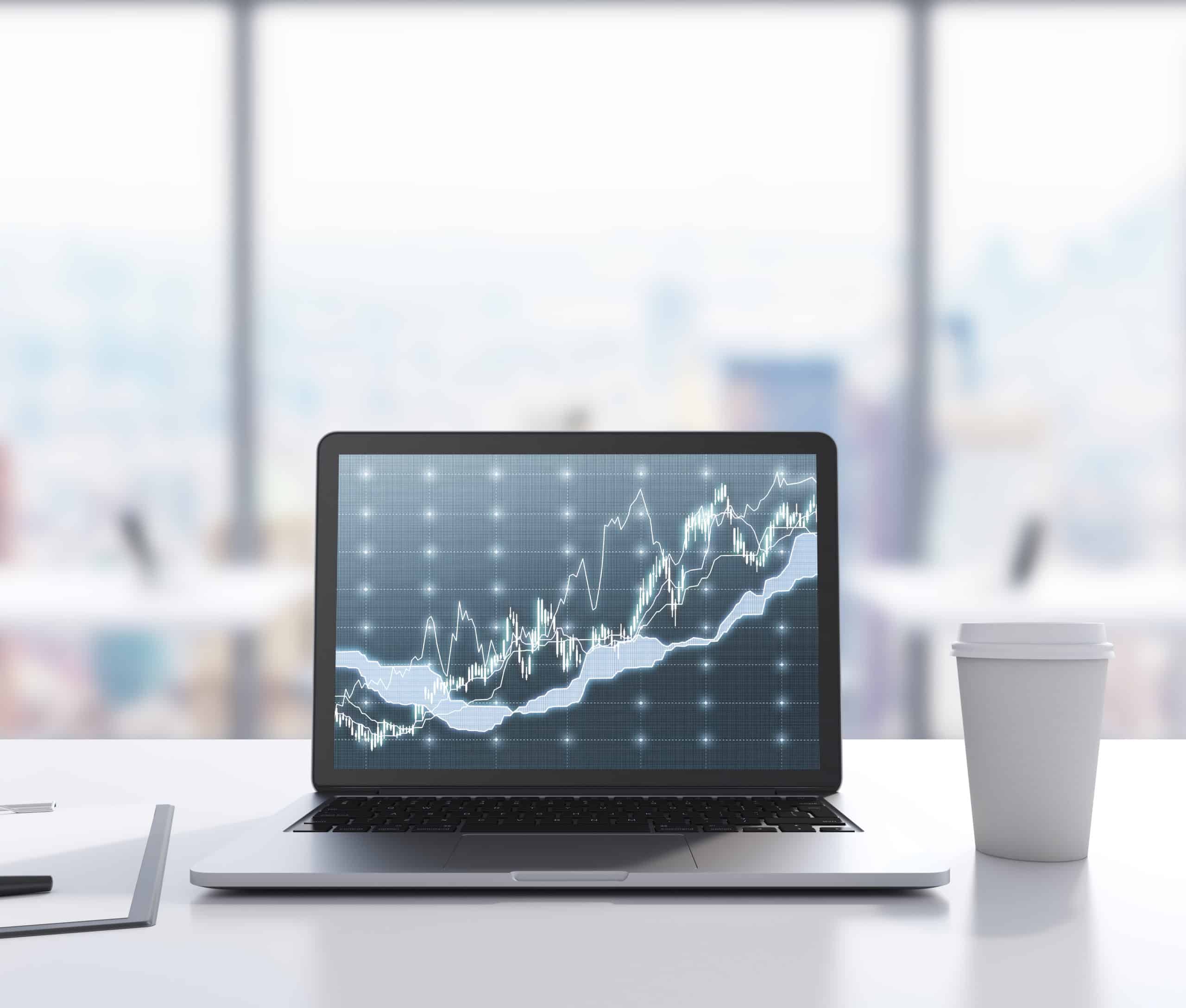 There are a laptop with forex chart on the screen, legal pad and a cup of coffee on the table. 3D rendering. Modern office with panoramic New York view in blur on the background. Toned image.