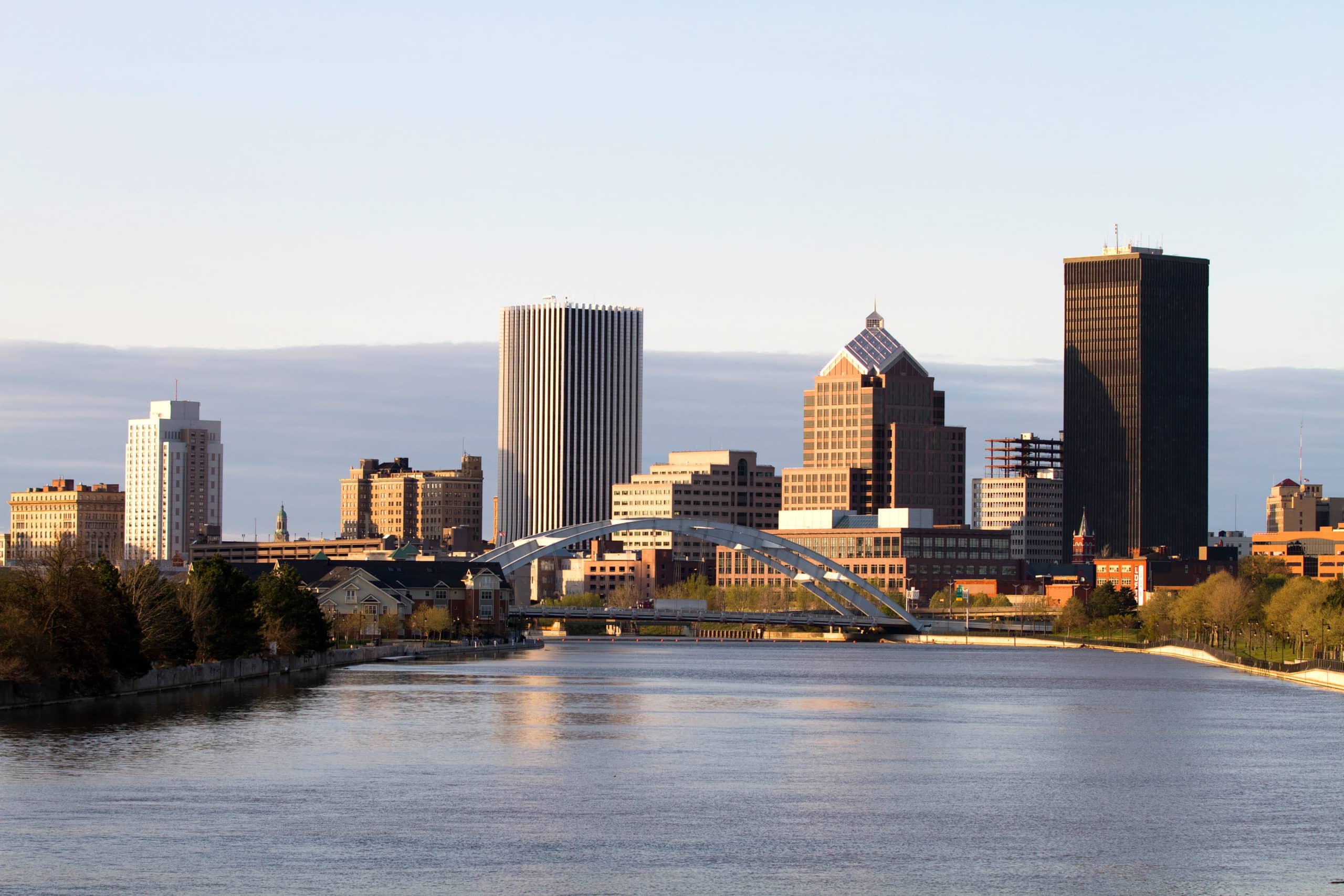 Rochester, New York, USA skyline viewed from the south at dusk with the Genesee River flowing toward the downtown area.