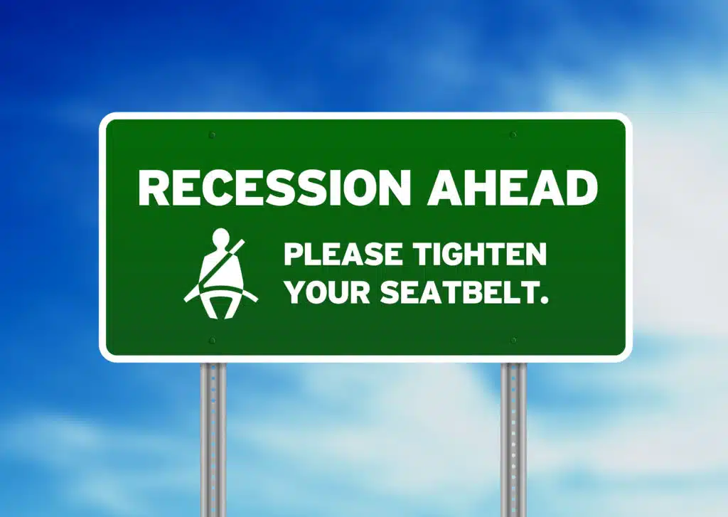 Green sign that reads "Recession Ahead".  Be prepared to protect yourself with the best recession proof stocks. 