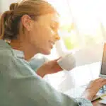 Trendy girl working from home on laptop and making money