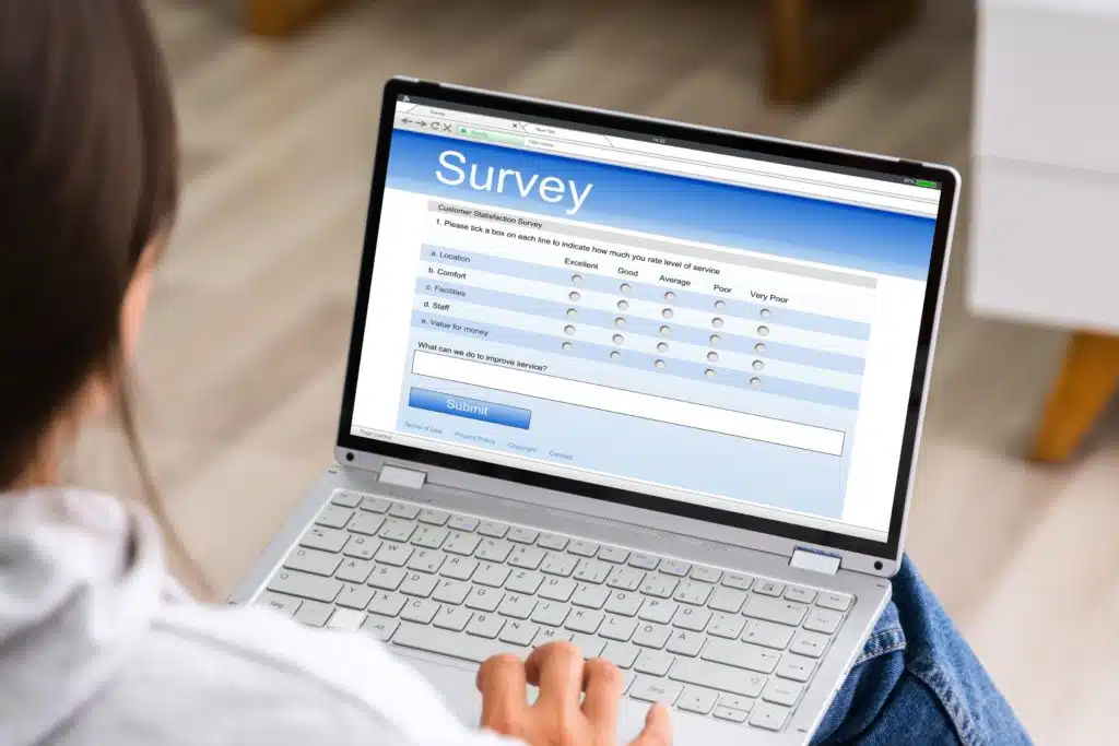 woman filling out an online survey on a laptop