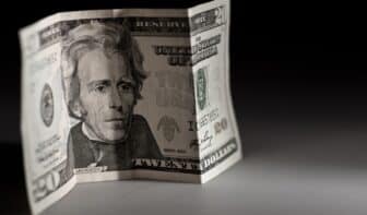 Twenty Bucks in the Dark. Twenty American Dollars Bill. Horizontal Studio Photo.