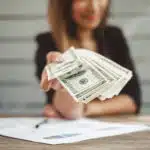 Woman accountant showing money dollars banknote, business financial concept for immediate cash value on life insurance