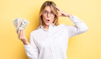 pretty blonde girl looking surprised, realizing a new thought, idea or concept of making 9 figures
